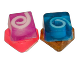 Four mini soaps. Purple with white swirl, blue with white swirl, pink with white swirl, brown with oatmeal pieces.