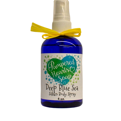 A 4 ounce blue bottle with yellow ribbon and white spray cap. Contains Deep Blue Sea scented body spray. Label reflects Pampered Hearts Soap logo and product name.