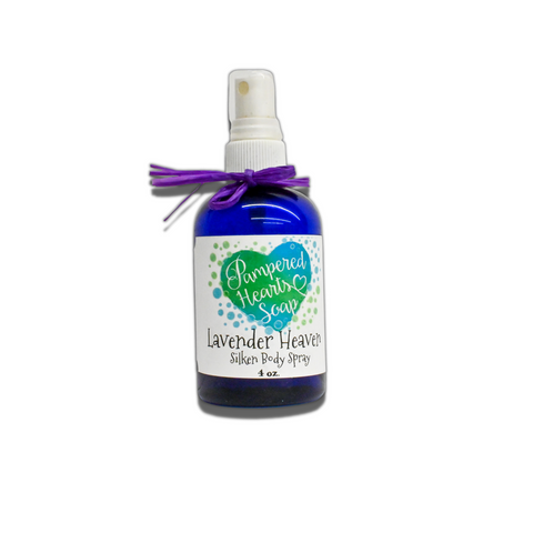 A 4 ounce blue bottle with purple ribbon and white spray cap. Contains Lavender Heaven scented body spray. Label reflects Pampered Hearts Soap logo and product name.