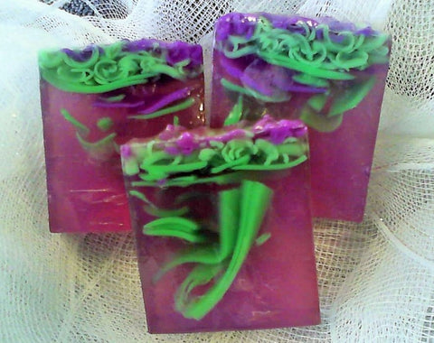 Square smooth glycerin soap bar, purple background with bright green swirls. Lilac scent. 