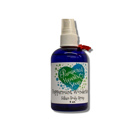 A 4 ounce blue bottle with red ribbon and white spray cap. Contains Peppermint Wonderland scented body spray. Label reflects Pampered Hearts Soap logo and product name.