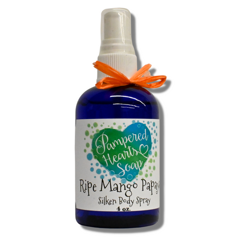 A 4 ounce blue bottle with orange ribbon and white spray cap. Contains Ripe Mango Papaya scented body spray. Label reflects Pampered Hearts Soap logo and product name.